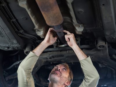 Mechanic servicing a car in repair shop