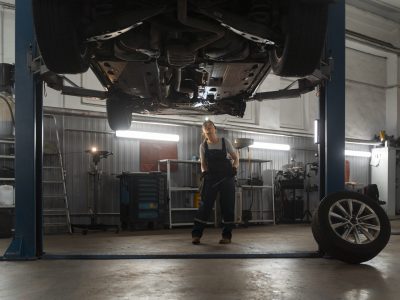female-auto-repairer-working-shop-car